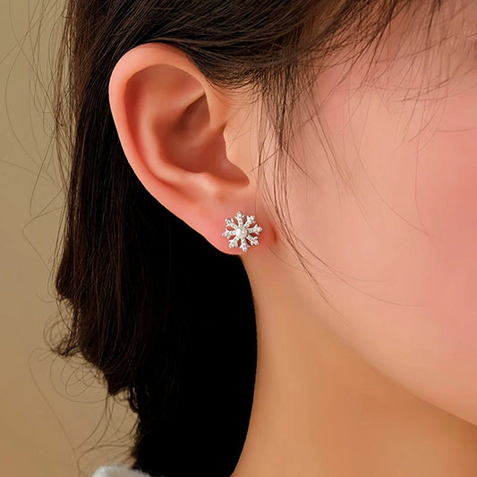 Model showcasing the dangle and style of the 14K Gold-Plated Chiristmas Snowflake Jacket Earrings