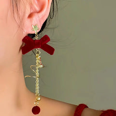 Close-up detail of the sparkling zircons and plating on the Christmas Bow Tassel Earrings