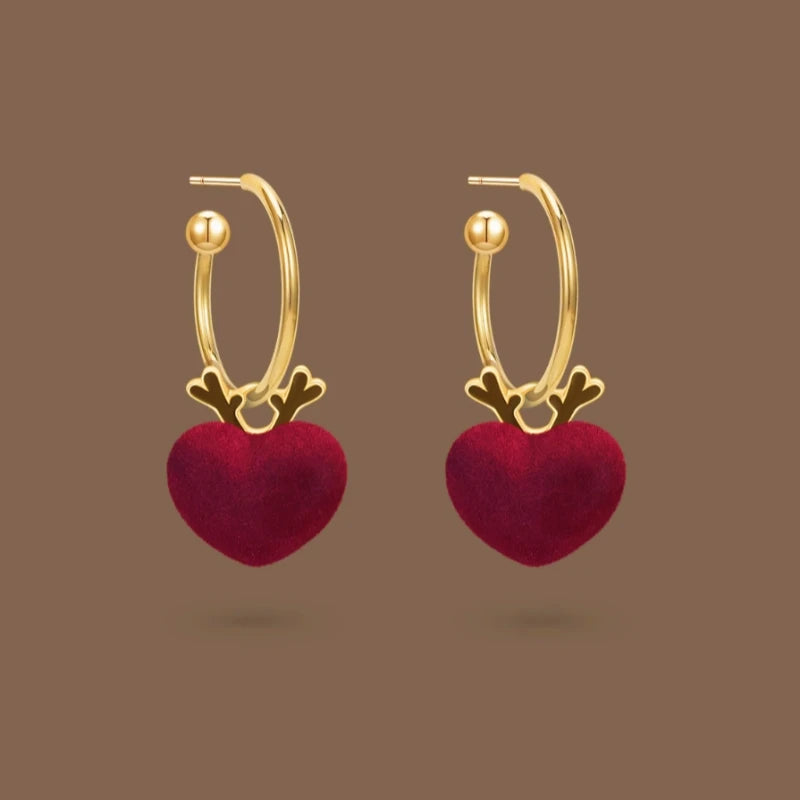 Model showcasing the dangle and style of the 14K Gold-Plated Christmas Deer Heart Earrings