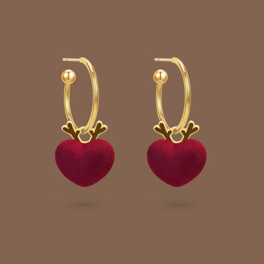 Model showcasing the dangle and style of the 14K Gold-Plated Christmas Deer Heart Earrings