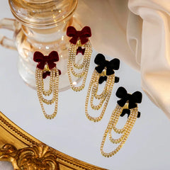 Close-up detail of the sparkling zircons and plating on the Flocked Bow Earrings