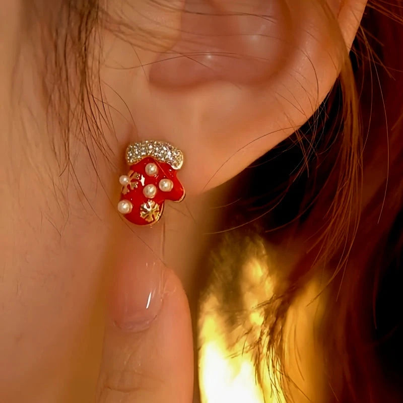 Model showcasing the dangle and style of the 14K Gold-Plated Christmas Diamond Asymmetrical Gloves And Hat Earrings