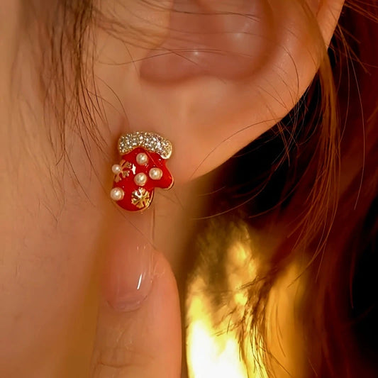 Model showcasing the dangle and style of the 14K Gold-Plated Christmas Diamond Asymmetrical Gloves And Hat Earrings