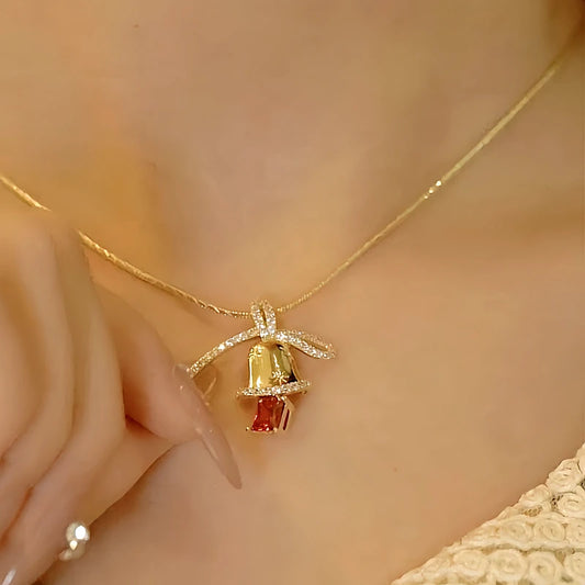 Model showcasing the dangle and style of the 14K Gold-Plated Christmas Diamond Bow Jingle Bell Series Earrings And Necklace