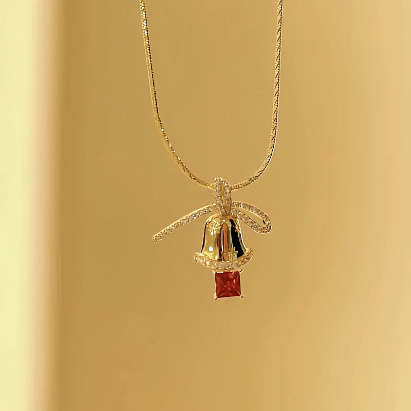 Angled view of the 14K Gold-Plated Christmas Diamond Bow Jingle Bell Series Earrings And Necklace