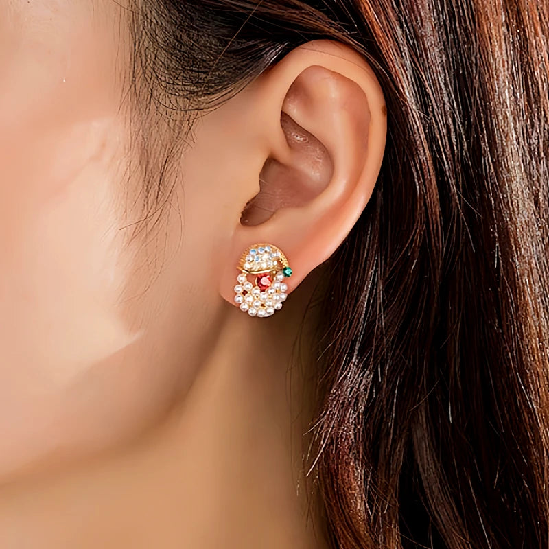 Angled view of the 14K Gold-Plated Christmas Diamond Peal Bell And Santa Stud Earrings