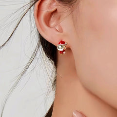 Model showcasing the dangle and style of the 14K Gold-Plated Christmas Diamond Santa Claus Earrings