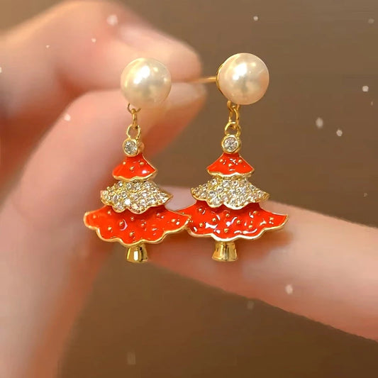 Model showcasing the dangle and style of the 14K Gold-Plated Christmas Diamond Zircon Artificial Pearl Christmas Tree Earrings