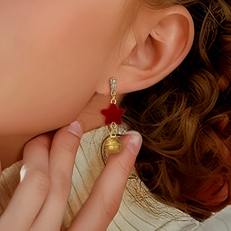 Angled view of the 14K Gold-Plated Christmas Red Star Bell Earrings