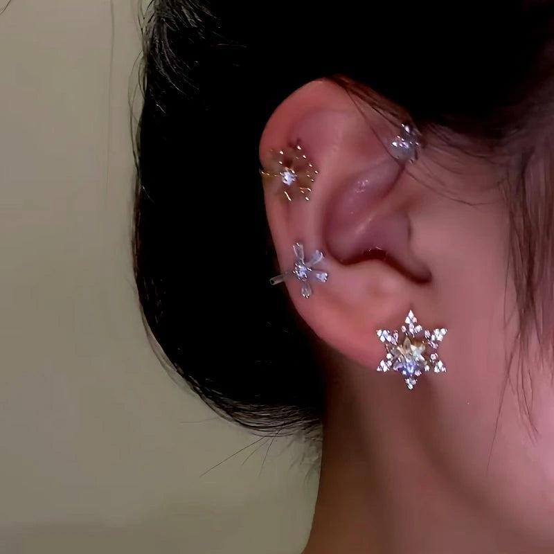 Model showcasing the dangle and style of the 14K Gold-Plated Christmas Rotating Snowflake Star Ear Cuffs