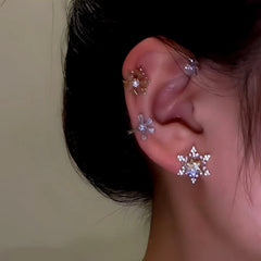 Model showcasing the dangle and style of the 14K Gold-Plated Christmas Rotating Snowflake Star Ear Cuffs