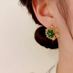 Model showcasing the dangle and style of the 14K Gold-Plated Christmas Rotating Zircon Snowflake Earrings