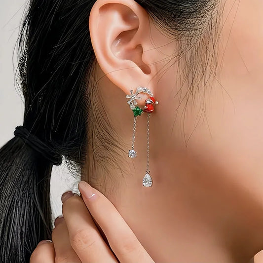 Model showcasing the dangle and style of the 14K Gold-Plated Christmas Santa Claus Snowflake Tassel Earrings