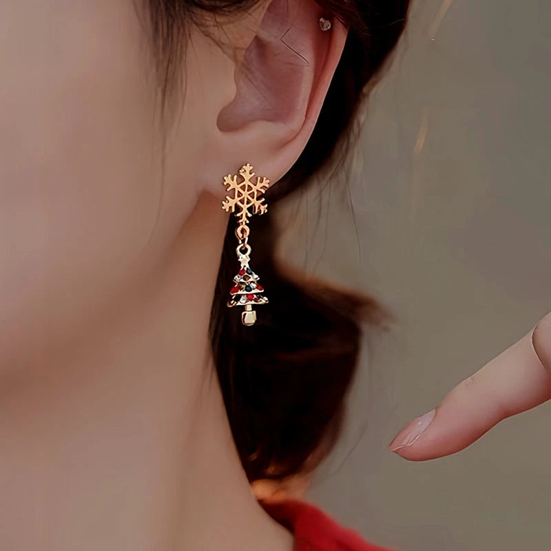 Model showcasing the dangle and style of the 14K Gold-Plated Christmas Snowflake Christmas Tree Earrings