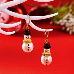 Angled view of the 14K Gold-Plated Christmas Snowflake Snowman Pendant Earrings