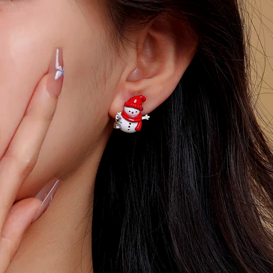 Model showcasing the dangle and style of the 14K Gold-Plated Christmas Snowman Stud Earring