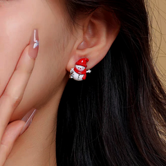 Model showcasing the dangle and style of the 14K Gold-Plated Christmas Snowman Stud Earring
