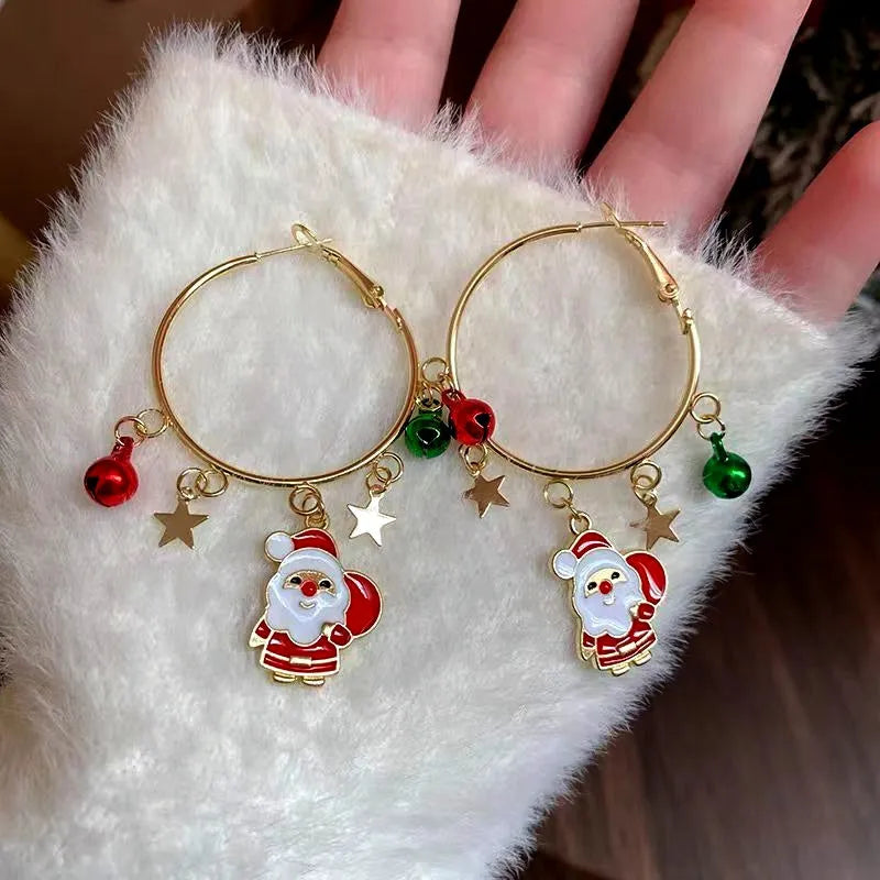 Angled view of the 14K Gold-Plated Christmas Tree And Santa Claus Hoop Tassel Earrings