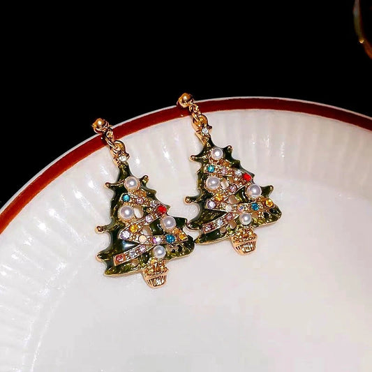 Model showcasing the dangle and style of the 14K Gold-Plated Christmas Tree Diamond And Pearl Earrings