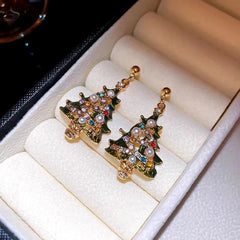 Angled view of the 14K Gold-Plated Christmas Tree Diamond And Pearl Earrings