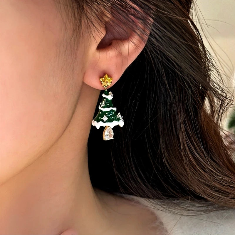 Model showcasing the dangle and style of the 14K Gold-Plated Christmas Tree Earrings