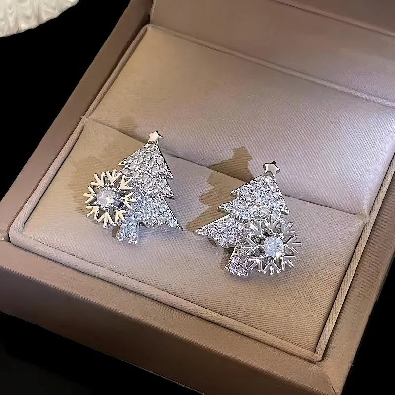 Model showcasing the dangle and style of the 14K Gold-Plated Christmas Tree Rotation Snowflake Stud Earrings