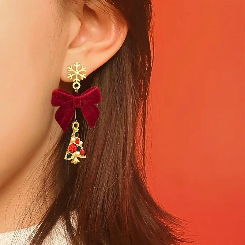 Model showcasing the dangle and style of the 14K Gold-Plated Christmas Tree Snowflake Bow Earrings