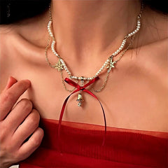 14K Gold-Plated Christmas Wine Red Bow Bell Beaded Snowflake Necklace worn to showcase its length and pendant detail