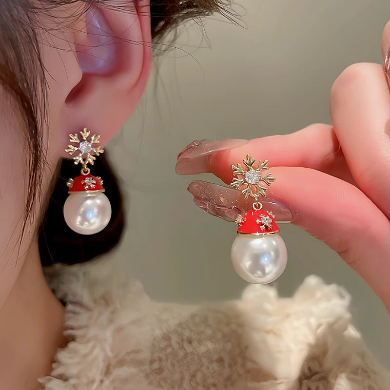Angled view of the 14K Gold-Plated Christmas Zircon Snowflake Hat Imitation Pearl Earrings