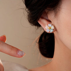 Model showcasing the dangle and style of the 14K Gold-Plated Colorful Flower Stud Earrings
