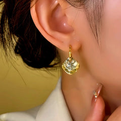 Close-up detail of the sparkling zircons and plating on the Irregular Pendant Earrings