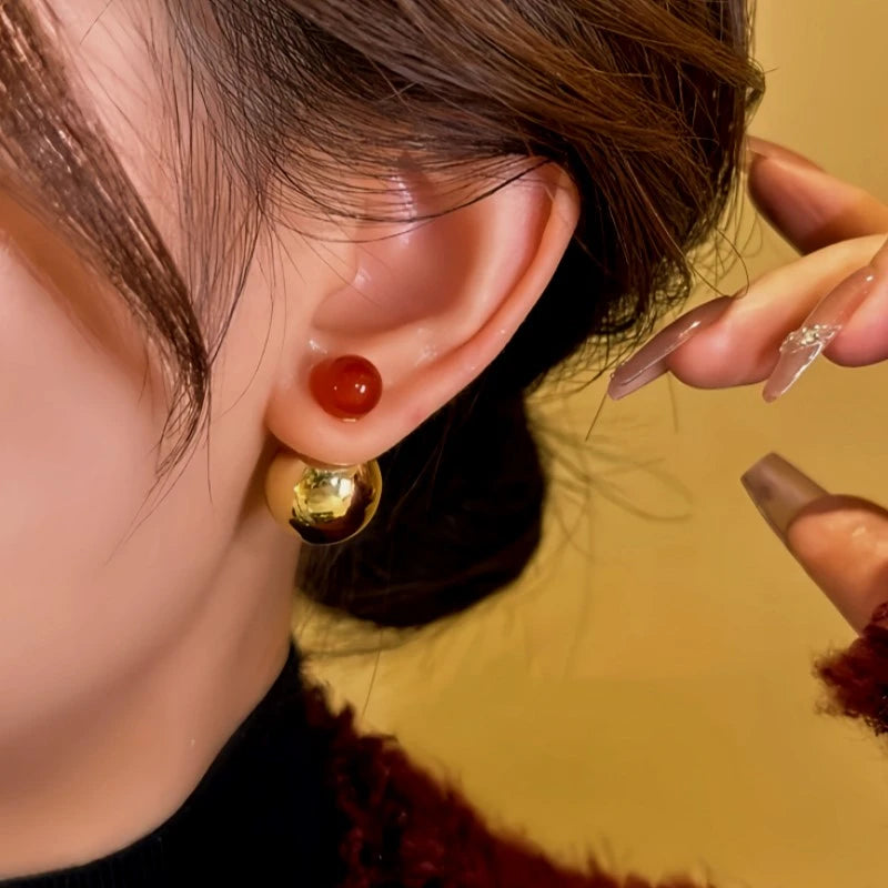 Model showcasing the dangle and style of the 14K Gold-Plated Contrasting Large And Small Beads Earrings