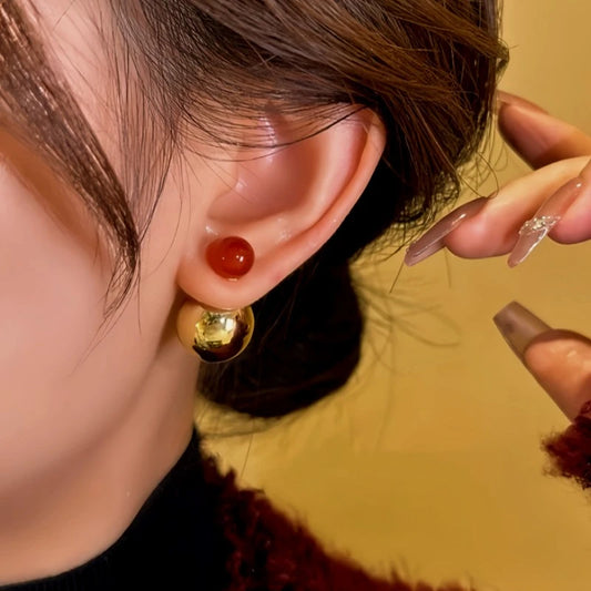 Model showcasing the dangle and style of the 14K Gold-Plated Contrasting Large And Small Beads Earrings