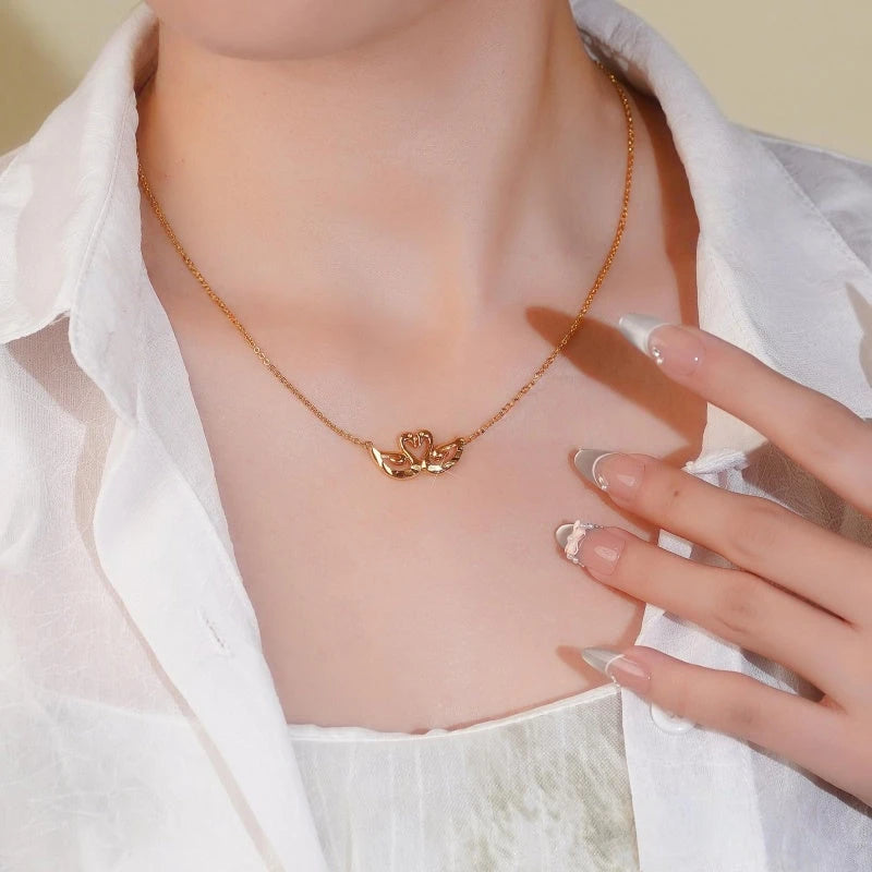 Detailed view of the 14K Gold-Plated Couple Swan Necklace chain and pendant