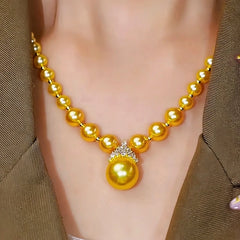 14K Gold-Plated Crown Gold Pearl Necklace worn to showcase its length and pendant detail