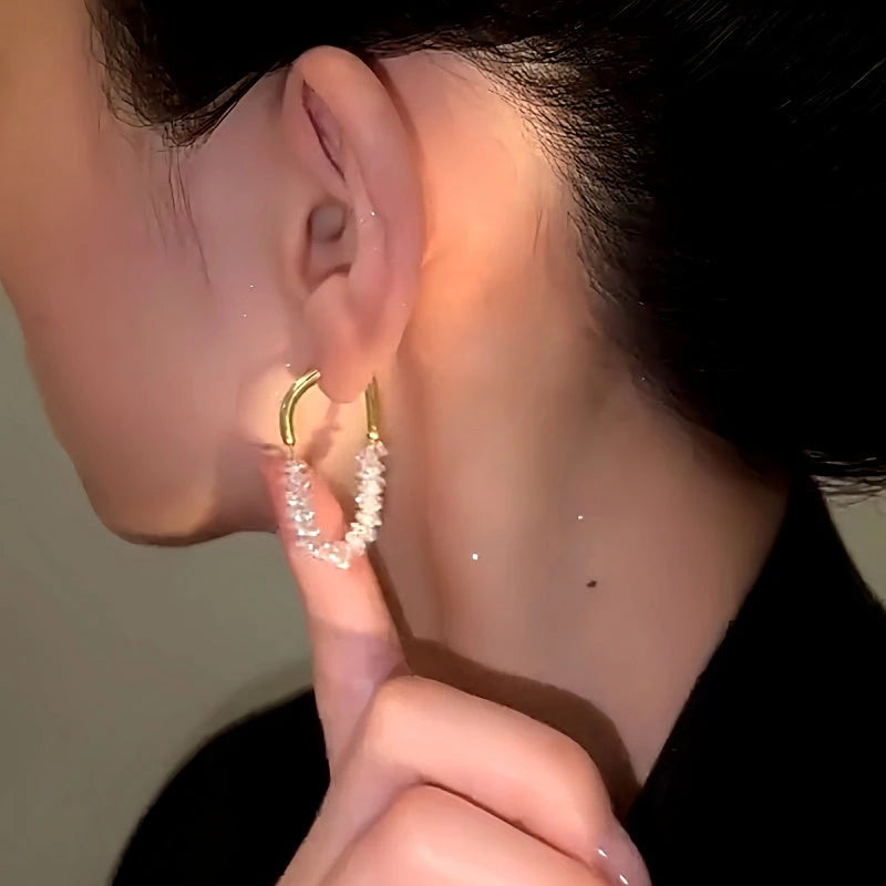 Model showcasing the dangle and style of the 14K Gold-Plated Crystal Beaded Earrings