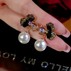 Angled view of the 14K Gold-Plated Crystal Flower Pearl Earrings