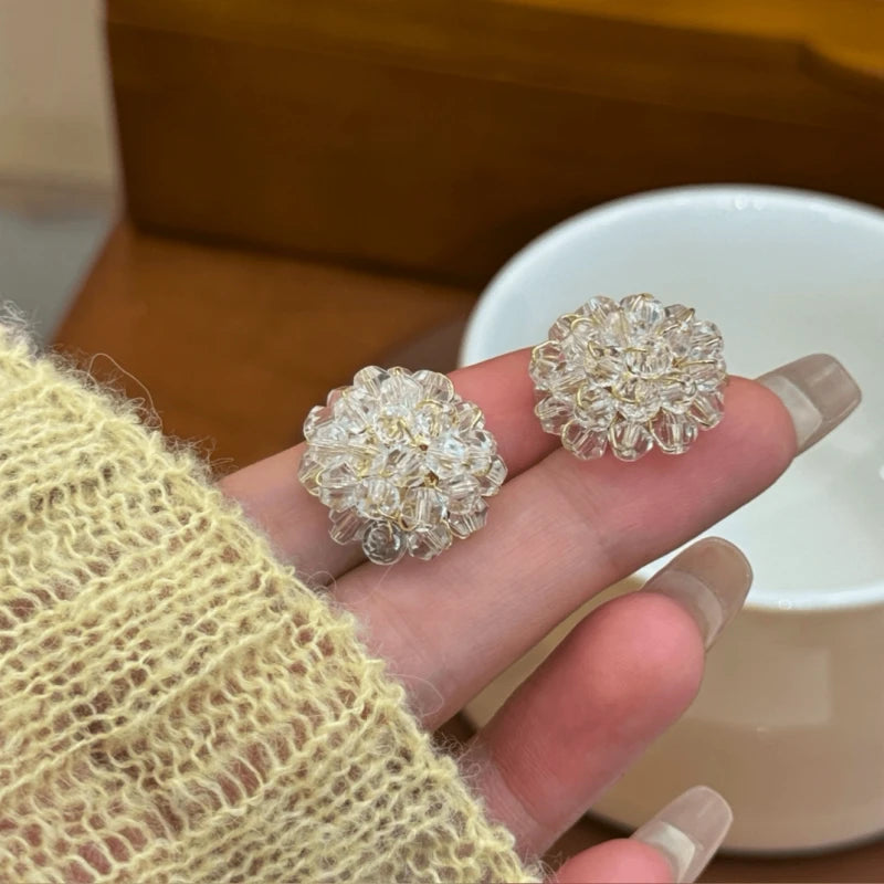 Angled view of the 14K Gold-Plated Crystal Flower Stud Earrings