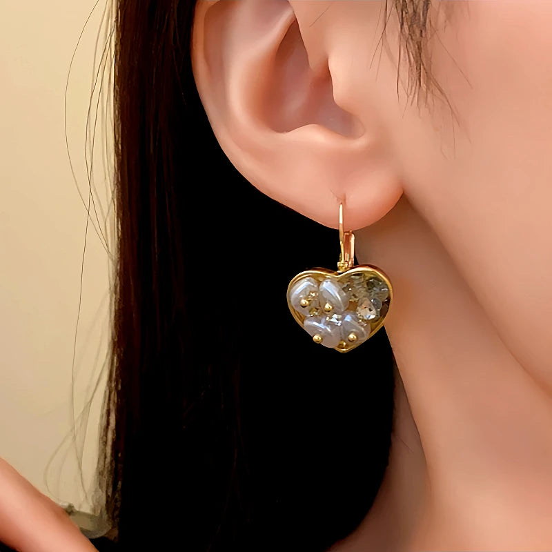 Angled view of the 14K Gold-Plated Crystal Heart-Design Earrings