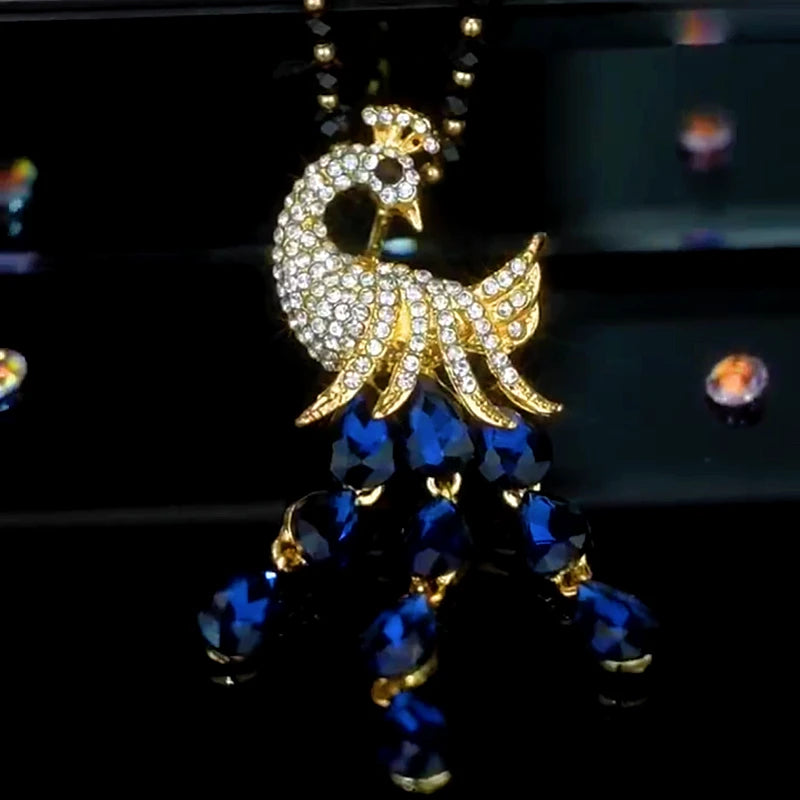 14K Gold-Plated Crystal Peacock Sweater Necklace worn to showcase its length and pendant detail