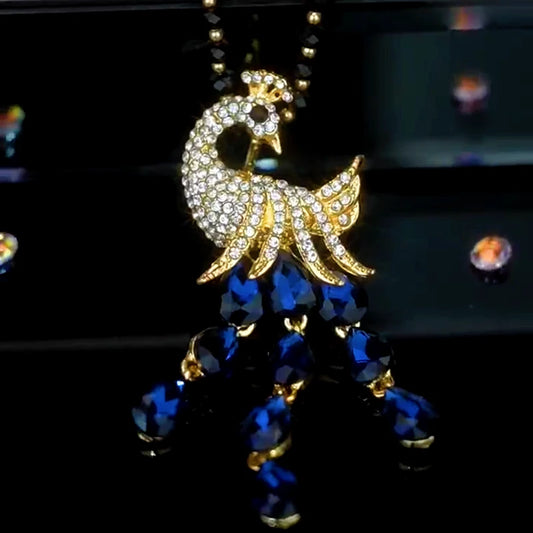 14K Gold-Plated Crystal Peacock Sweater Necklace worn to showcase its length and pendant detail