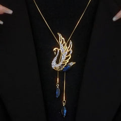 Close-up of the pendant and clasp on the Swan Sweater Necklace