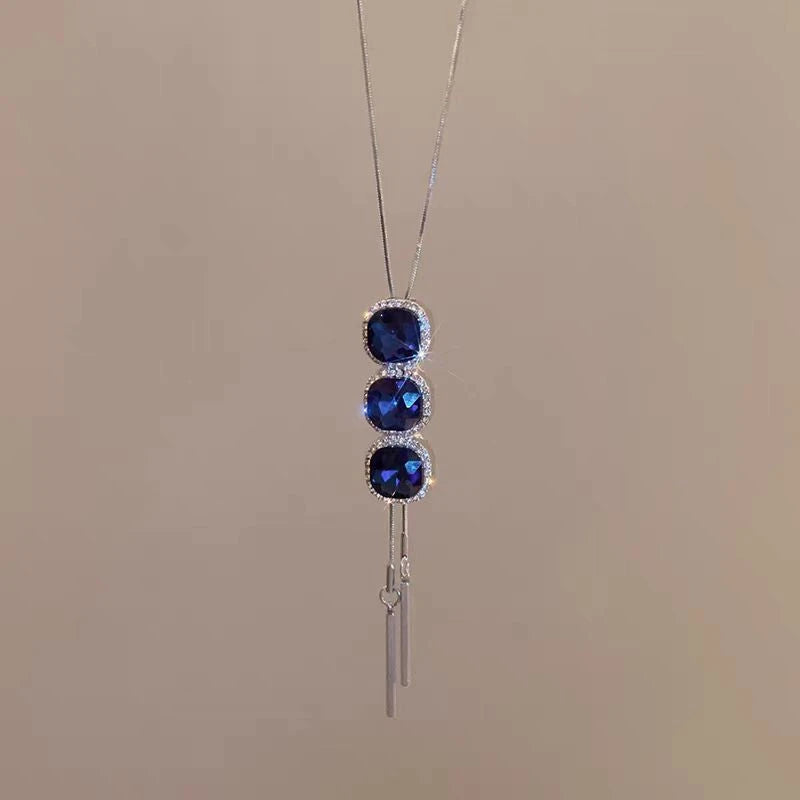 Close-up of the pendant and clasp on the Blue Crystal Sweater Necklace