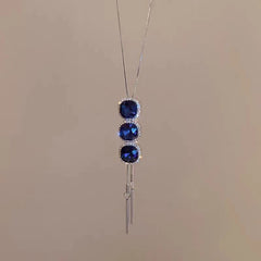 Close-up of the pendant and clasp on the Blue Crystal Sweater Necklace
