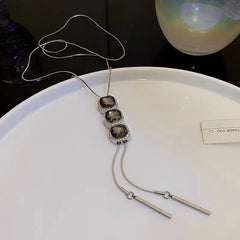 Detailed view of the 14K Gold-Plated Crystal Sweater Chain Necklaces chain and pendant