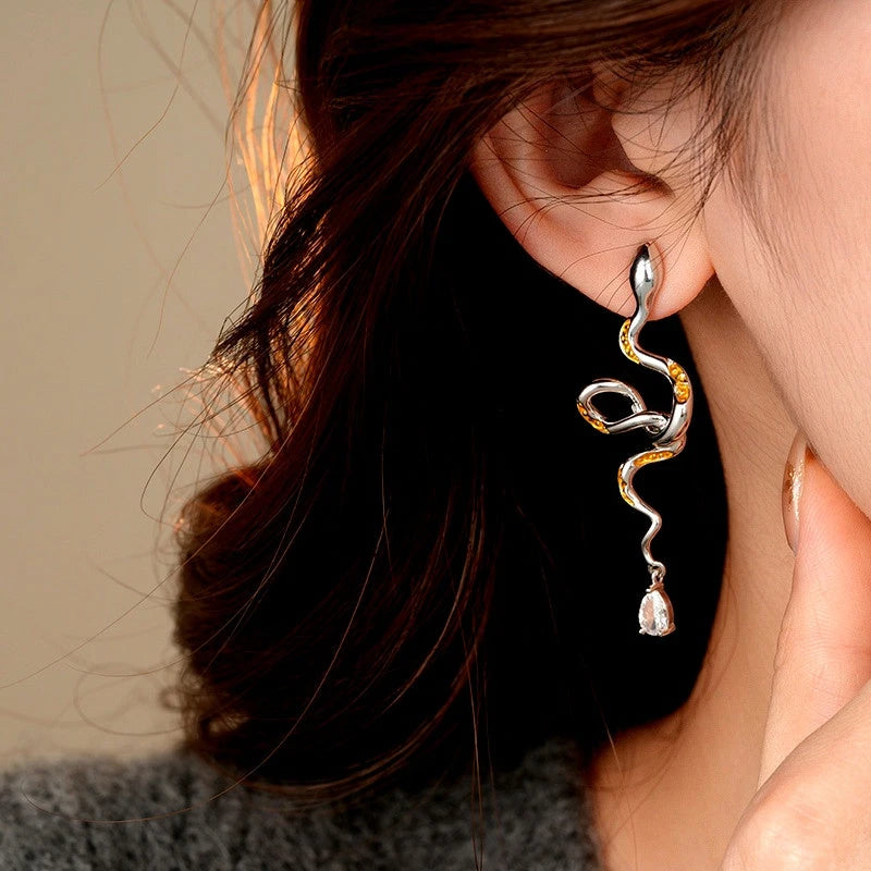 Model showcasing the dangle and style of the 14K Gold-Plated Curved Snake Zircon Water Drop Earrings