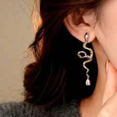 Model showcasing the dangle and style of the 14K Gold-Plated Curved Snake Zircon Water Drop Earrings