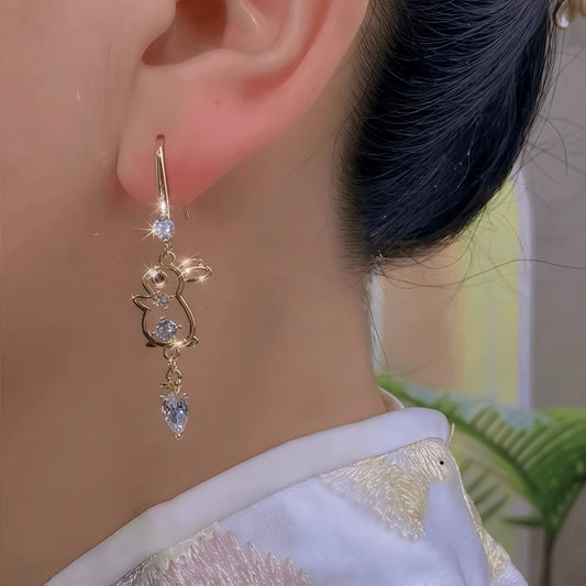 Model showcasing the dangle and style of the 14K Gold-Plated Cute Zircon Diamond Rabbit Ear Hook Earrings