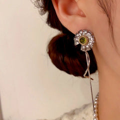 Model showcasing the dangle and style of the 14K Gold-Plated Daisy Long Tassel Earrings