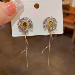 Angled view of the 14K Gold-Plated Daisy Long Tassel Earrings